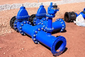 Hot Water Tank 7 blue valves and pipes on a dirt surface 2026 03 25 23 59 05 utc